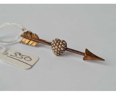 A gold arrow and heart brooch 