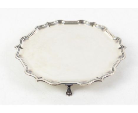 Modern silver salver with Chippendale style border supported on three pad feet, by C J Vander Ltd, and retailed by Harrods, S