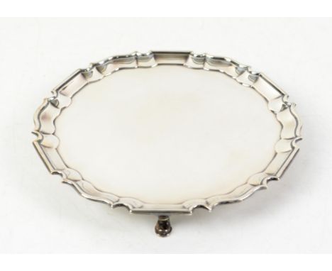 George V silver salver with Chippendale style border supported on three pad feet, by Johnson, Walker & Tolhurst, London 1927,