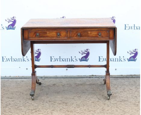 19th century style crossbanded mahogany sofa table, with two frieze drawers, on reeded outsplayed legs with brass lion paw fe