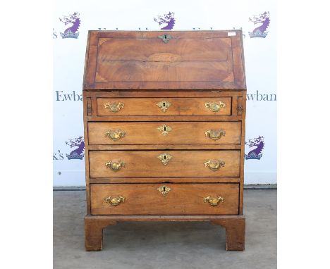 Late 18th century oak fall front bureau, the top and flap veneered with mahogany and inlaid fan and shell paterae, with four 