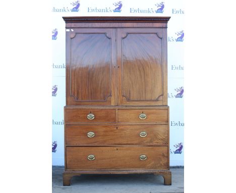 Early 19th century mahogany linen press, the moulded cornice over a pair of panelled doors enclosing linen shelves over two s