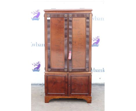 Mahogany converted cabinet, the rising top over a pair of rosette and reeded panelled doors over further doors on bracket fee