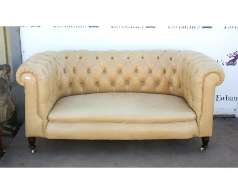 Chesterfield sofa, covered in a cream leatherette, on turned tapering legs and pot castors, H78 W168 D83 cm