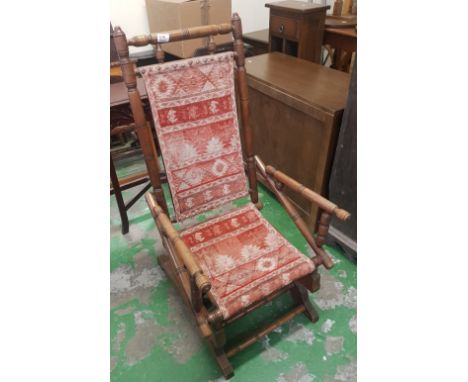 An American rocking chair with First Nation style fabric. 