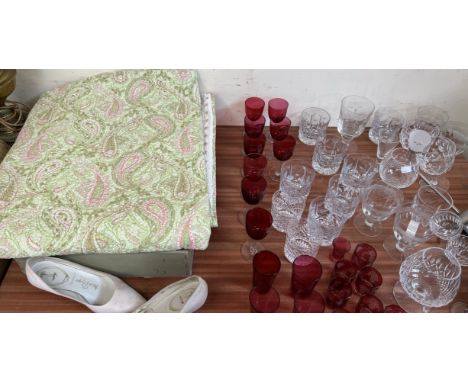 A bed spread together with cranberry glass and other drinking glasses etc 