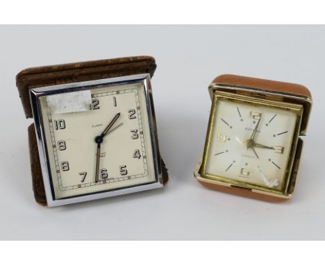A Smiths Art Deco travel alarm clock in folding leather case, one further travel alarm clock.
PLEASE NOTE: ALL ITEMS MUST BE 