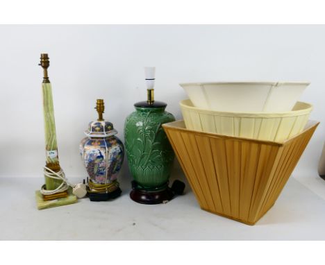 Three table lamps and shades to include a tall green onyx and brass example. Chinese style, celadon, largest approximately 55