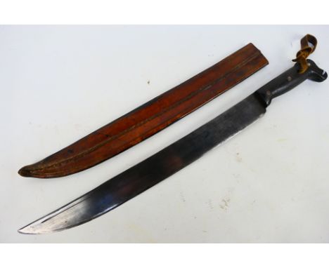 An antique machete with carved wooden grip and 45 cm (l) blade, contained in leather sheath, 59 cm (l) overall. [W]
Note: Thi