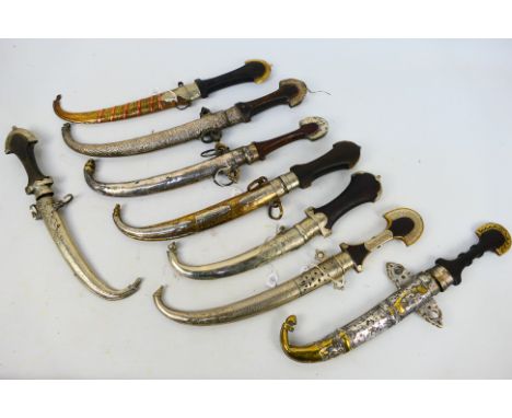 A group of 19th century and later Moroccan koummya type daggers with scabbards, largest approximately 42 cm (l). [W]
Note: Th