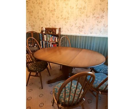 Ercol - An Ercol circular topped extending dining table and six Quaker dining chairs, table approximately 72 cm x 114 cm (114