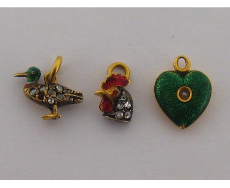 A mixed lot comprising a  yellow metal (tests as 18 carat gold) and seed pearl heart shaped charm, 11mm wide, a yellow metal 