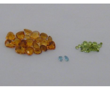 A group of loose cut peridots, citrines and aquamarines, the circular cut peridots 2 - 4mm diameter, 0.64 gms gross (3.21 car