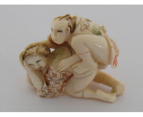 An early 20th century Japanese carved ivory erotic netsuke, carved and decorated in the round, unsigned, with double threadin