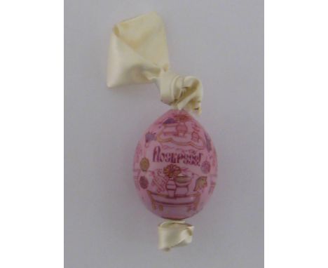 A Russian ceramic pink Easter egg with enamel and gilt decoration on a satin ribbon.
 CONDITION REPORT: No chips, cracks or o