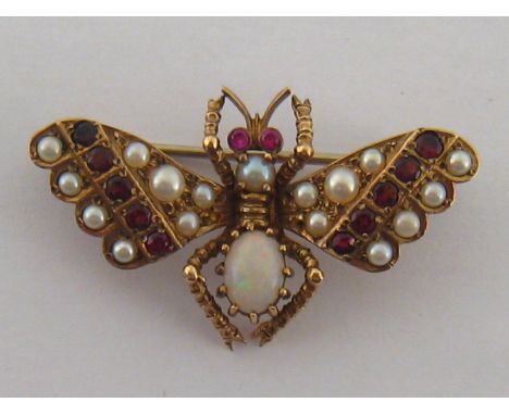 A late Victorian garnet, ruby, seed pearl and opal insect brooch, the yellow metal body (tests as 15 carat gold) 39 x 22mm, 5