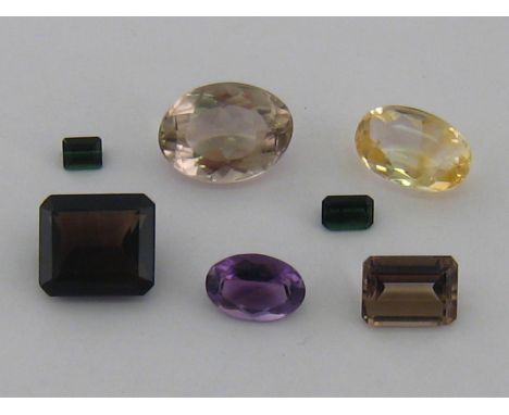 A quantity of loose polished gemstones including an oval citrine, 15.23 ct, an amethyst 8.09 ct and a smokey quartz 22.78 ct.