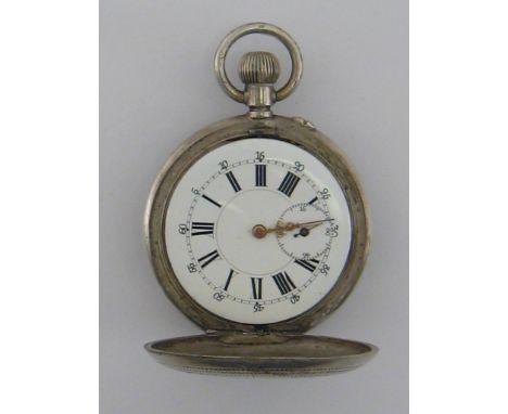 A late 19th century white metal full hunter pocket watch, with indistinct standard mark on the pendant, numbered 317 to the f