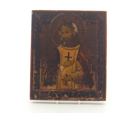 A 19th. century Russian icon of a patriarch, the figure within a punched , engraved and painted wooden surround. 26x31cm.  CO
