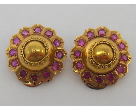 A pair of 19th century yellow metal (tests as high carat gold) and ruby ear clips, of boss form, each round cut ruby approxim