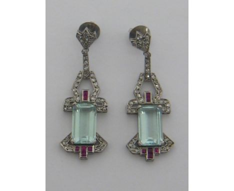 A pair of Art Deco aquamarine, diamond and ruby pendant earrings, mounted in white metal (tests as high carat white gold), th