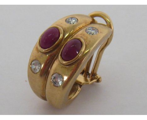 A yellow metal (tests as 14 carat gold), cabochon ruby and white sapphire single earring, the two cabochon rubies 5.9 x 4.1mm