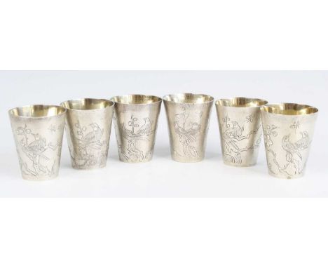 A harlequin set of six Chinese export white metal beakers, circa 1900, each of typical tapering form with planished finish an