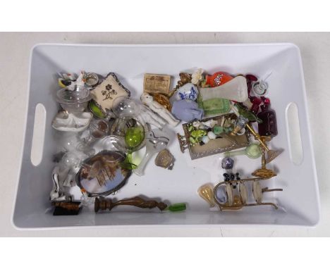 A collection of dolls house miniatures, to include a three-tier cake stand, ruby glass decanter and glasses, and a table cent