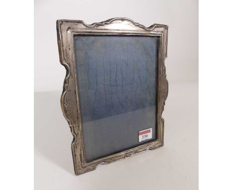 A George V silver clad easel photograph frame of shaped rectangular outline, maker William Hutton &amp; Sons Ltd, Chester, 19