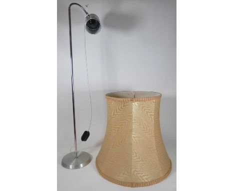 A contemporary brushed aluminium reading light on a weighted base, height 107cm, together with a table top mounted magnifier 