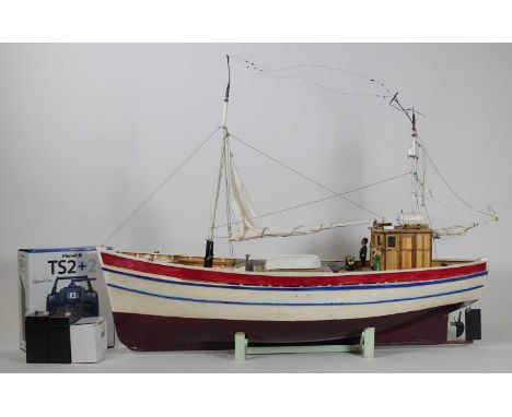 A painted wooden remote controlled model of a fishing boat 'Amelia', length 84cm, with stand and remote control