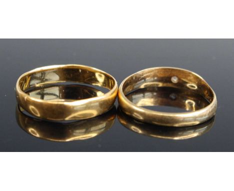 A 22ct gold wedding band, size K (misshapen), 2.2g; together with an 18ct gold band ring gypsy set with a small round cut dia