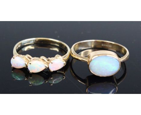A modern 14ct gold triple opal set dress ring, size P, 2.3g; together with a 9ct gold cabochon opal set dress ring, size N, 2