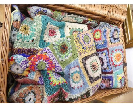 A large wicker picnic hamper, containing a woollen crochet work and homemade bed cover 