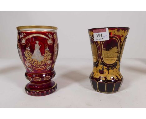 A late 19th century Bohemian gilt decorated ruby glass vase, decorated with architectural views within oval cartouches, heigh