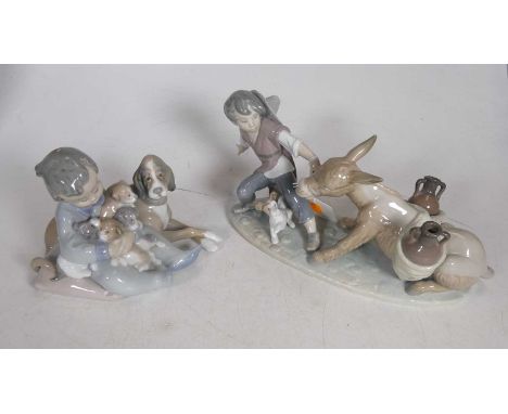 A Lladro Spanish porcelain figure modelled as a young boy pulling a laden donkey with a dog at his feet on naturalistic oval 
