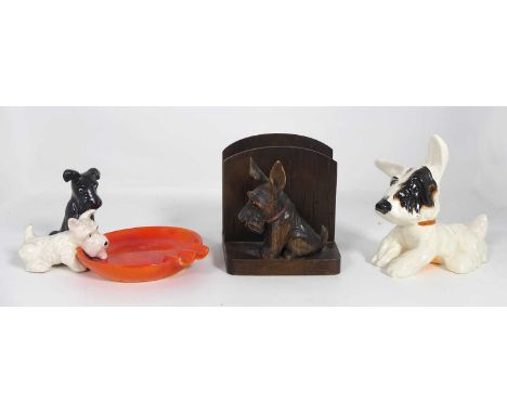 A Crown Devon pottery figure of a Scottish terrier, h.12cm; together with a novelty ceramic ashtray; and a letter-rack (3)