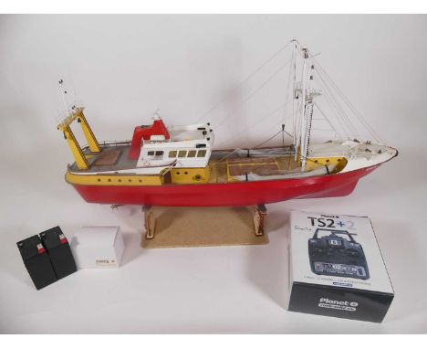 A remote controlled model of a fishing boat, length 88cm, on stand, with remote control
