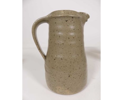 A Leach pottery jug, having a mottled green glaze and single loop handle, impressed mark, height 19cm