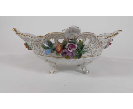 A Dresden floral painted and floral encrusted  table bowl having a pierced and shaped rim standing on scrolled foliate feet, 