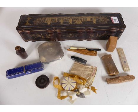 An early 20th century Japanese export box, black lacquered with gilt decoration, containing a collection of items to include 