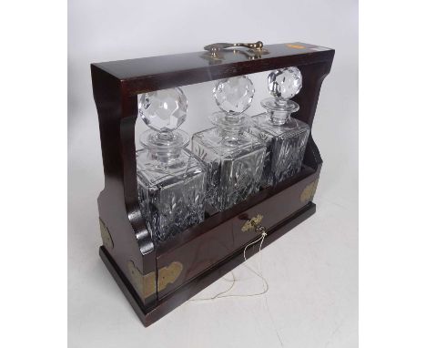A reproduction brass mounted mahogany three-decanter tantalus, h.28cm 