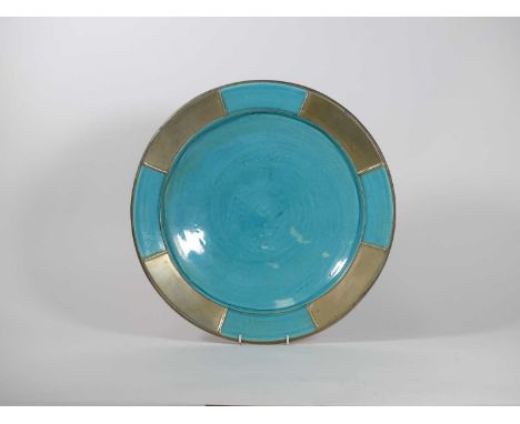A North African blue glazed and metal mounted earthenware charger, dia.41.5cm 