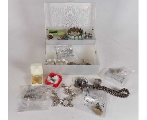 A collection of jewellery, to include a silver charm bracelet with padlock clasp and various suspended novelty charms, rings,