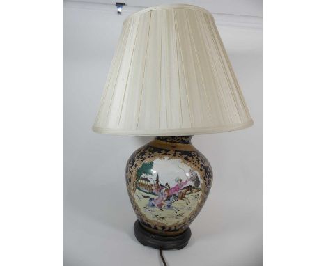A contemporary pottery table lamp, decorated with hunting scene within a gilt foliate cartouche, further gilt decoration on b