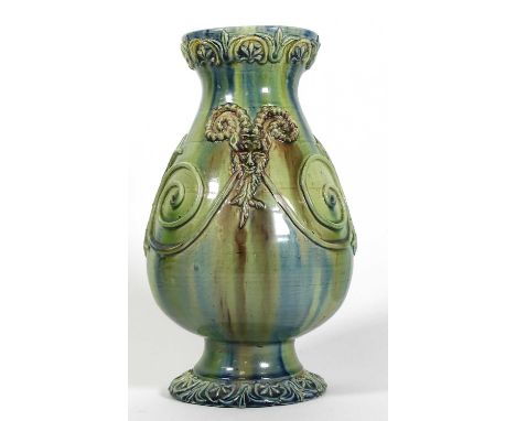 An Victorian art pottery vase, having a streaked green-blue glaze and applied mask decoration, unmarked but possibly Castle H