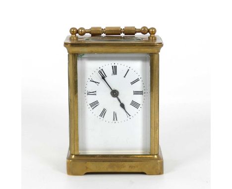 An ealry 20th century French lacquered brass carriage clock, having a visible platform escapement, the white enamel dial with