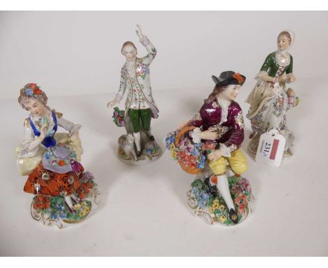 A pair of early 20th century Sitzendorf porcelain figures of a lady and gentleman, each modelled as standing with lamb at the