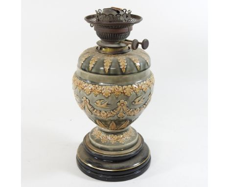 A 19th century Royal Doulton style oil lamp, the reservoir bearing the name Hinks &amp; Sons, 34cm high overall
