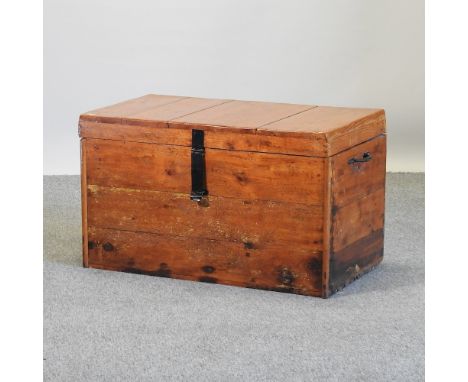 An antique pine trunk, with metal handles, 83cm
